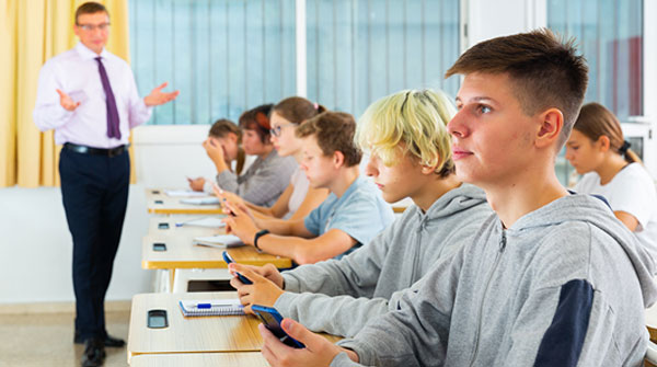 Students in class using digital devices