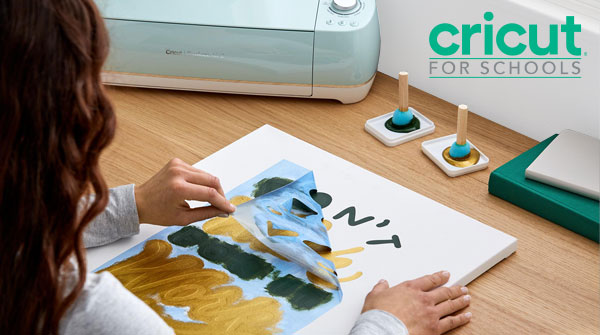 Student creating a project using Cricut cut out stencil