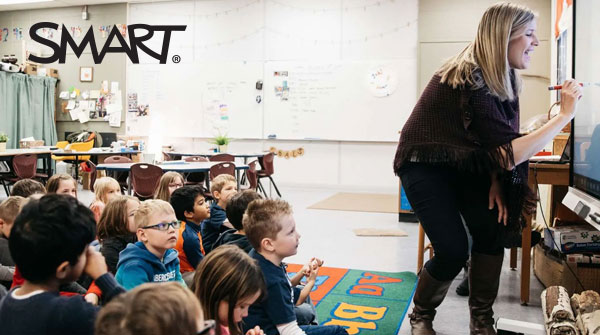 Teacher using SMART Board to guide young learners