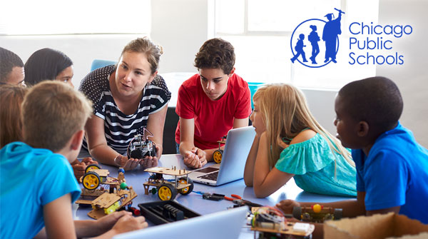 Students working on robotics with teacher with Chicago Public Schools logo