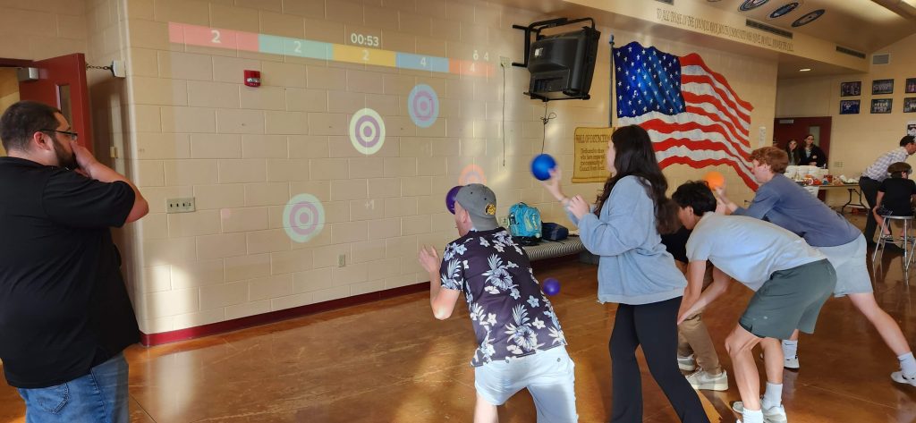 High school students playing games with Lü.